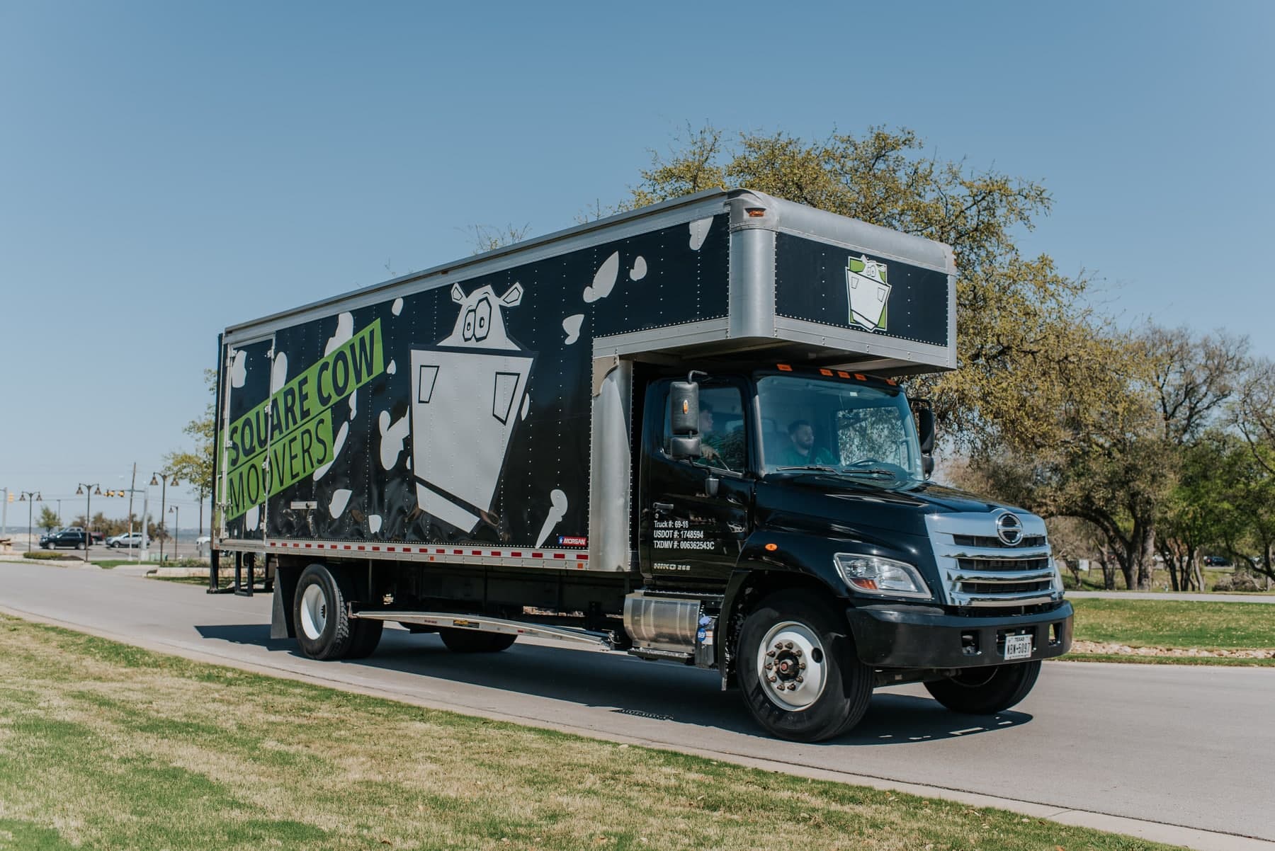 Square Cow movers carefully wrapping furniture for a residential move